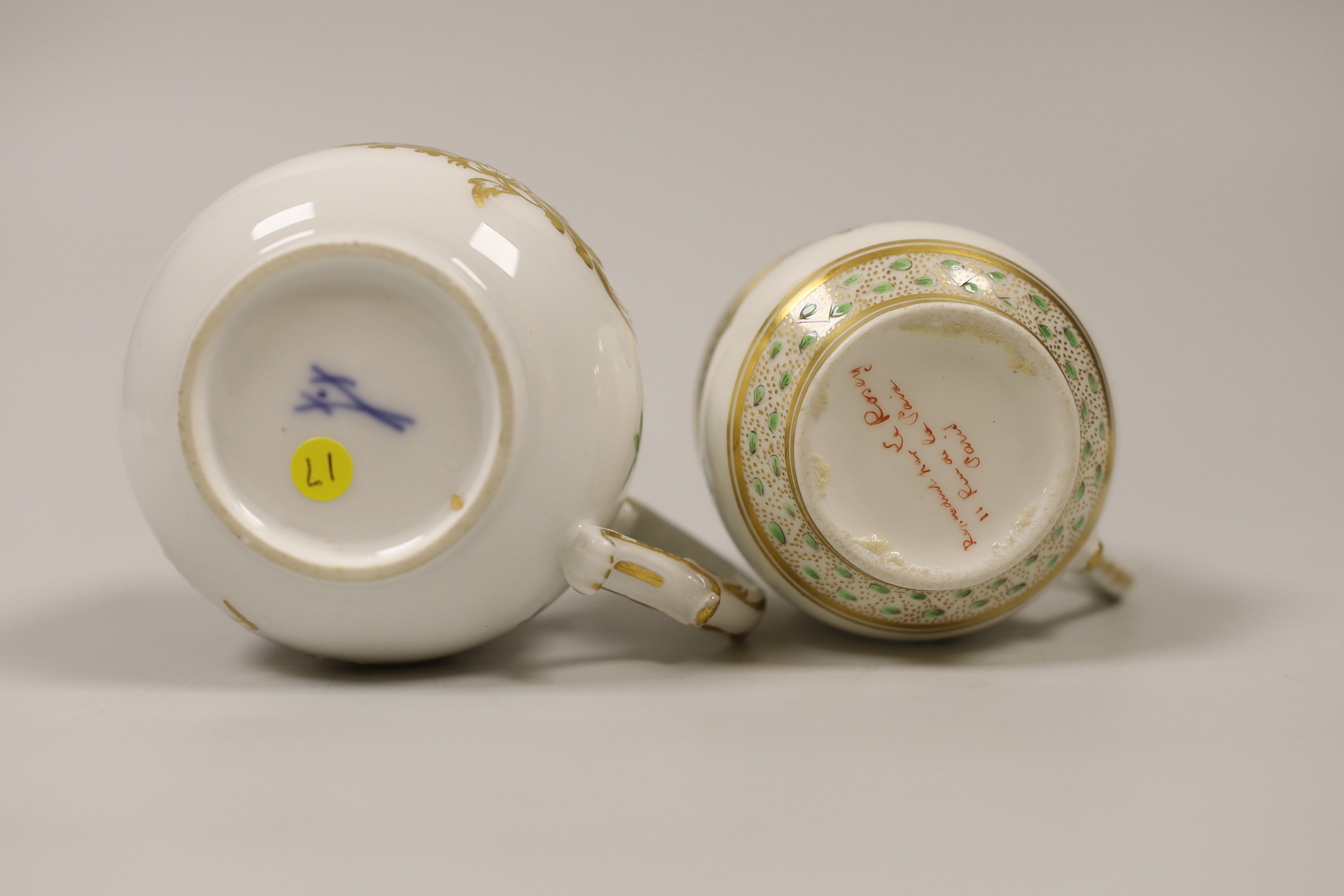 An 18th century Meissen custard cup and cover painted with flowers in Sevres style, crossed swords dot in blue, and a 19th century Paris porcelain custard cup and cover painted with chains of flowers, the largest 9cm hig